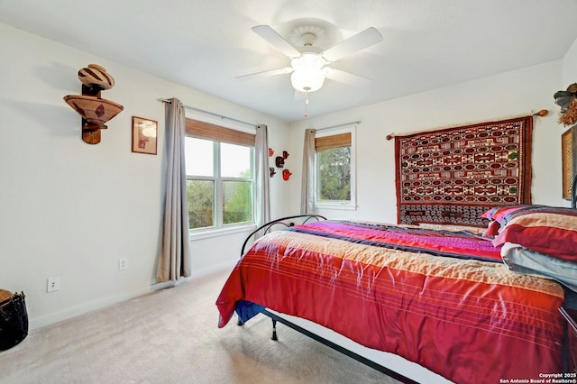 carpeted bedroom featuring ceiling fan and baseboards