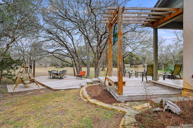 deck with outdoor dining area and a pergola