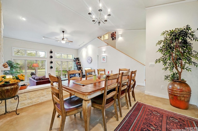 dining space with lofted ceiling, finished concrete flooring, baseboards, and ceiling fan with notable chandelier