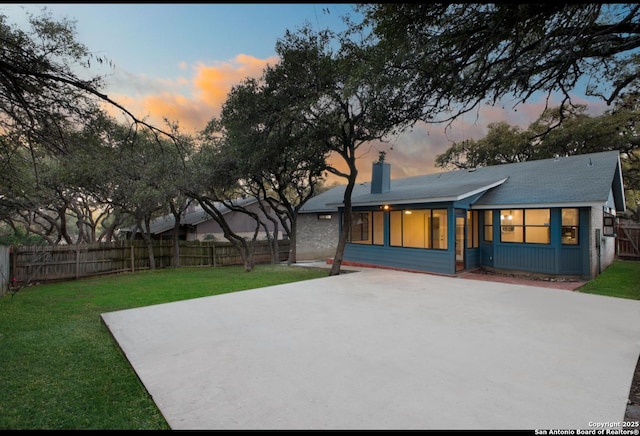 exterior space with fence private yard, a chimney, and a front yard