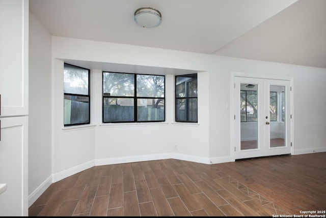 spare room with a healthy amount of sunlight, dark wood-style floors, and baseboards