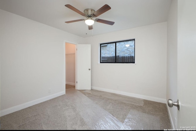 unfurnished room featuring light colored carpet, ceiling fan, and baseboards