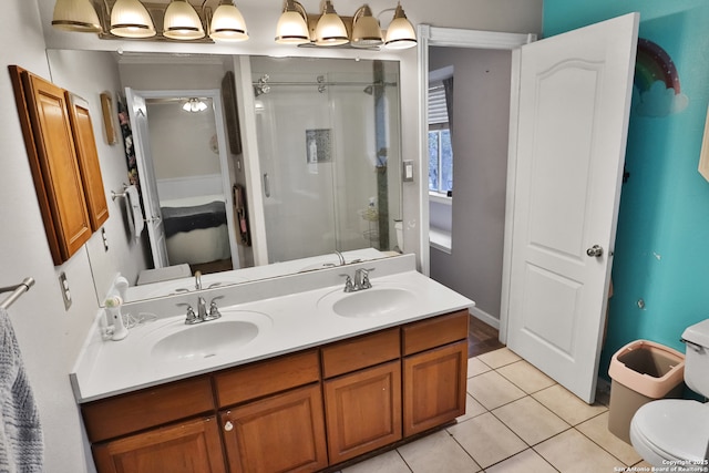 4114 Luckenbach, San Antonio, TX 78251 - bathroom featuring double vanity, toilet, a stall shower, a sink, and tile patterned flooring