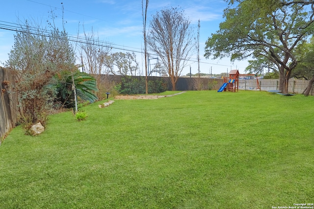4114 Luckenbach, San Antonio, TX 78251 - view of yard featuring a playground and a fenced backyard