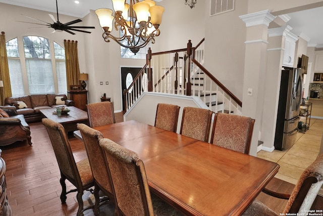 4114 Luckenbach, San Antonio, TX 78251 - dining space with a towering ceiling, visible vents, stairs, light wood finished floors, and decorative columns