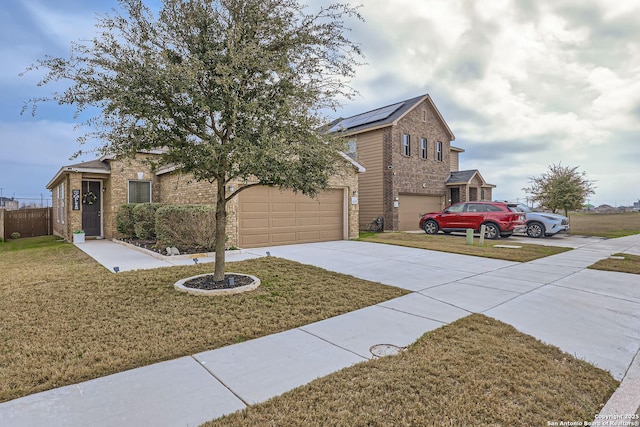 view of front of house with driveway, a front yard, a garage, and brick siding