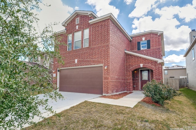 traditional home with a garage, concrete driveway, fence, a front lawn, and brick siding