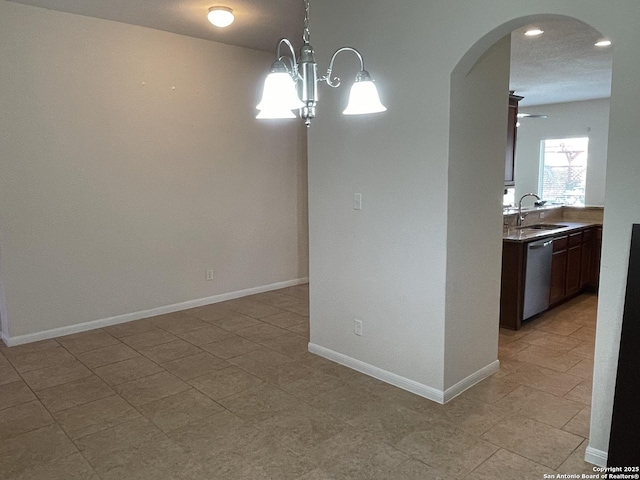 interior space featuring baseboards, arched walkways, a sink, and recessed lighting