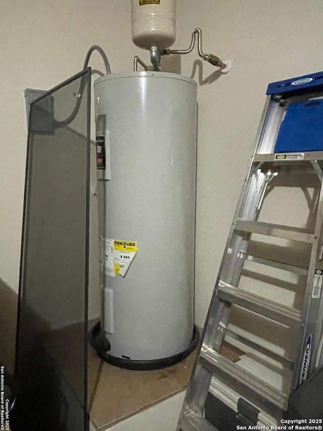 utility room featuring water heater