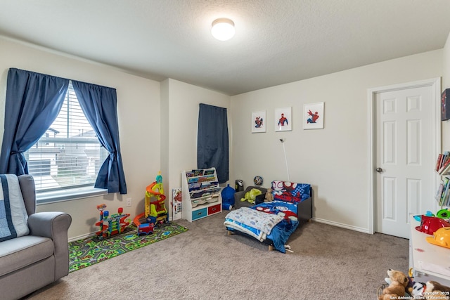 bedroom featuring a textured ceiling, baseboards, and carpet flooring