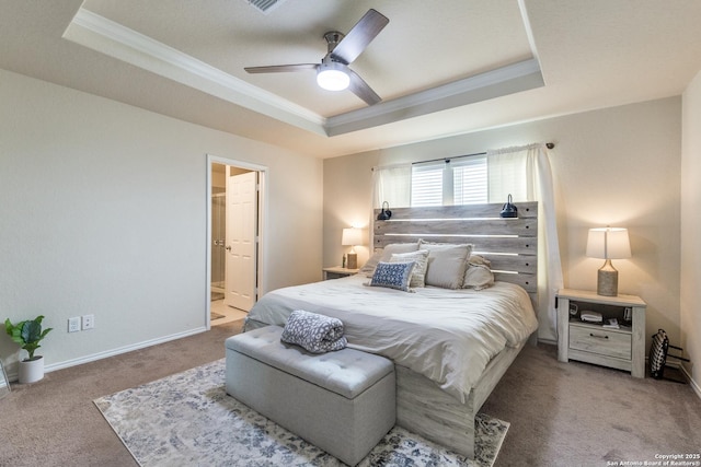 bedroom featuring crown molding, a raised ceiling, light carpet, connected bathroom, and baseboards