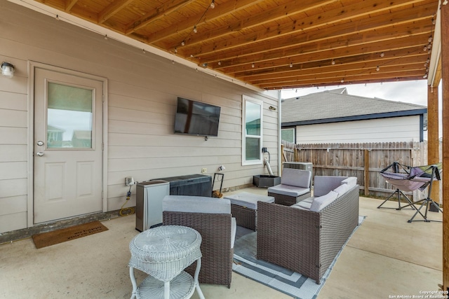 view of patio featuring fence and outdoor lounge area