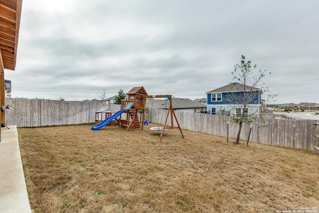 view of play area featuring a fenced backyard and a yard