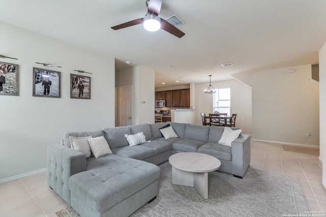 living room featuring light tile patterned floors, baseboards, and visible vents