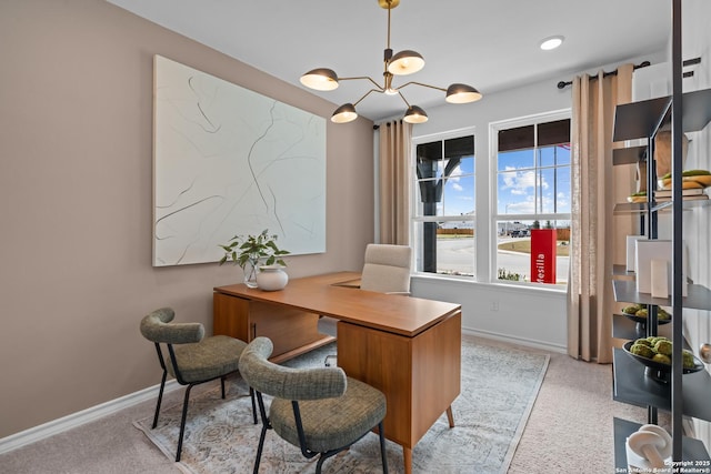 home office featuring baseboards and a notable chandelier