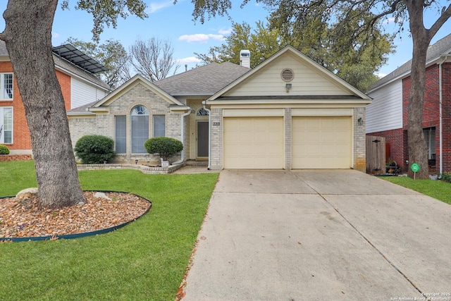 view of front of home featuring a front lawn, brick siding, a chimney, and an attached garage