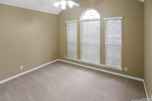 unfurnished room featuring lofted ceiling, carpet floors, ceiling fan, and baseboards