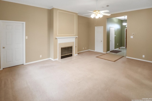 unfurnished living room with a tile fireplace, light colored carpet, crown molding, and visible vents