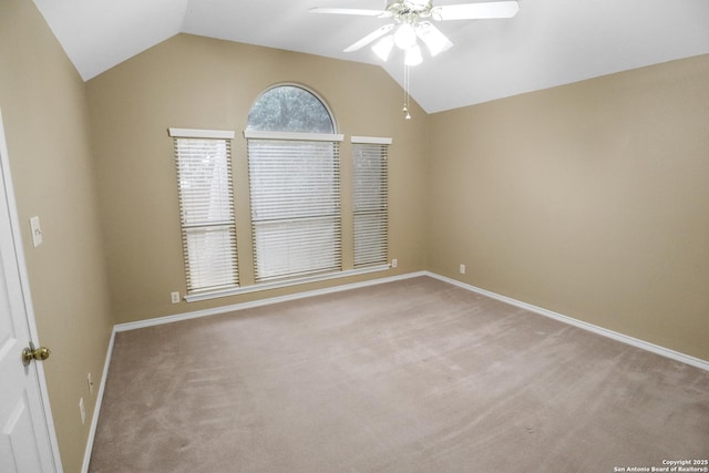 unfurnished room featuring lofted ceiling, ceiling fan, baseboards, and light colored carpet