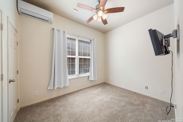 carpeted spare room featuring ceiling fan, baseboards, and a wall mounted AC