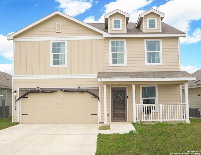 view of front facade with an attached garage, central AC unit, and board and batten siding