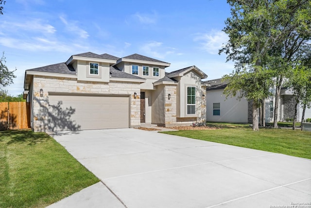 prairie-style home featuring a garage, concrete driveway, stucco siding, fence, and a front yard