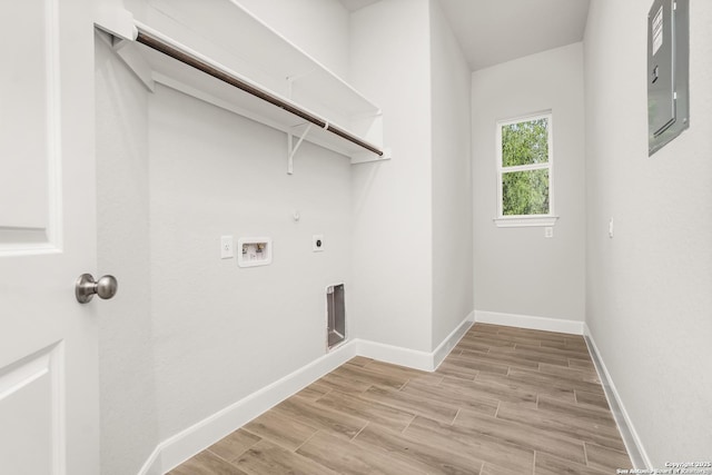 washroom featuring laundry area, baseboards, hookup for a washing machine, hookup for an electric dryer, and light wood-style floors