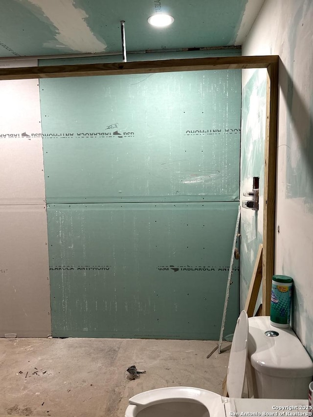 bathroom with unfinished concrete flooring