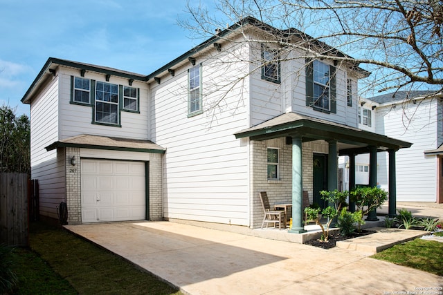 view of front of home with a garage, concrete driveway, brick siding, and covered porch