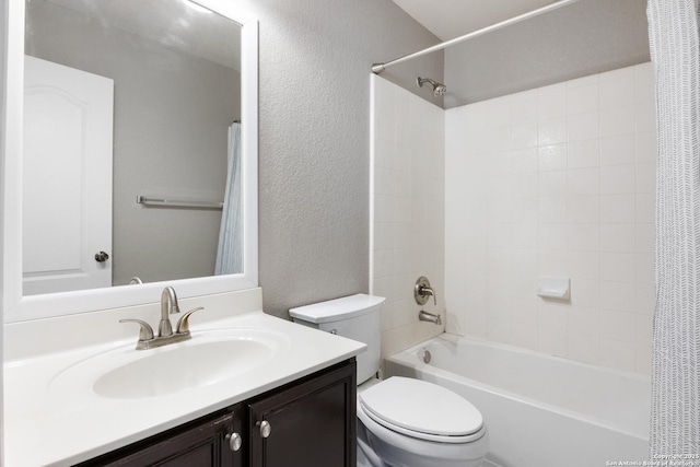 bathroom with toilet, a textured wall, shower / tub combo with curtain, and vanity