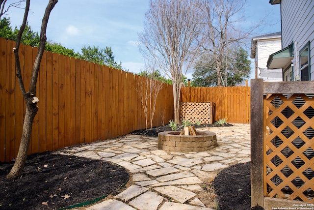 view of patio / terrace with a fenced backyard and a fire pit