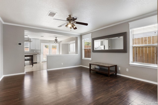 unfurnished living room featuring ornamental molding, visible vents, dark wood finished floors, and a textured ceiling