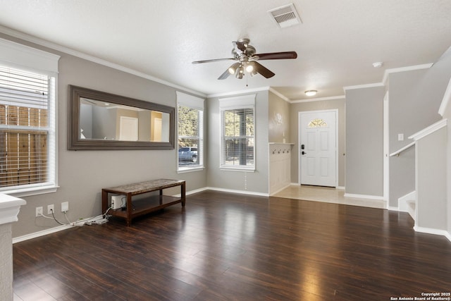 entrance foyer featuring dark wood-type flooring, visible vents, ornamental molding, and stairs