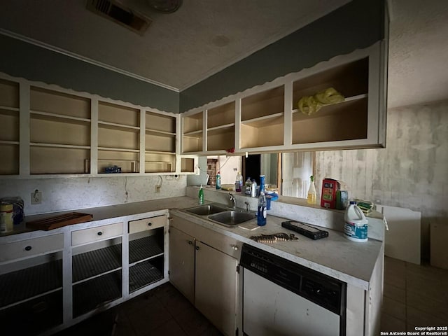 204 Dogwood Ln, Kountze, TX 77625 - kitchen with dark tile patterned flooring, light countertops, stainless steel dishwasher, open shelves, and a sink