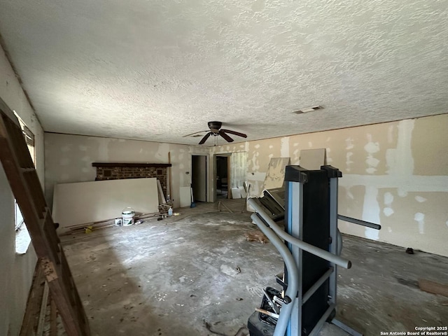 204 Dogwood Ln, Kountze, TX 77625 - unfurnished living room featuring a fireplace, visible vents, and a textured ceiling