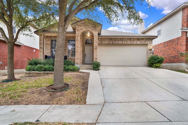 view of front of house featuring concrete driveway, brick siding, and an attached garage