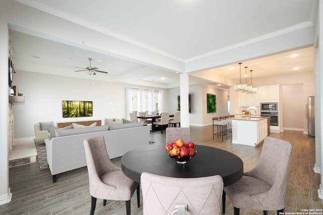 dining space featuring recessed lighting, light wood-style flooring, ornamental molding, ceiling fan, and baseboards