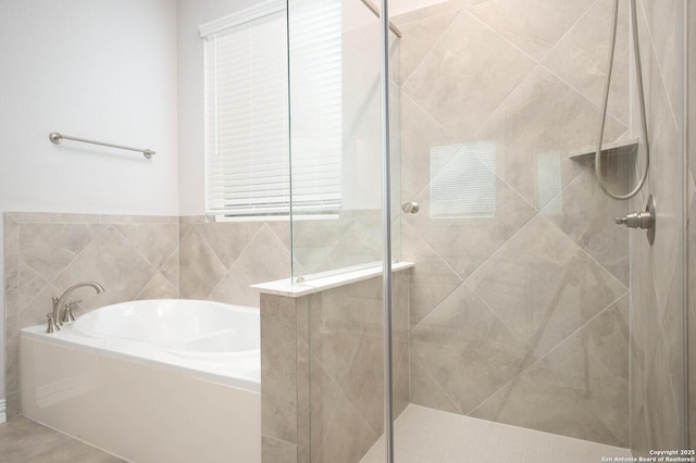 bathroom with a stall shower and a bath