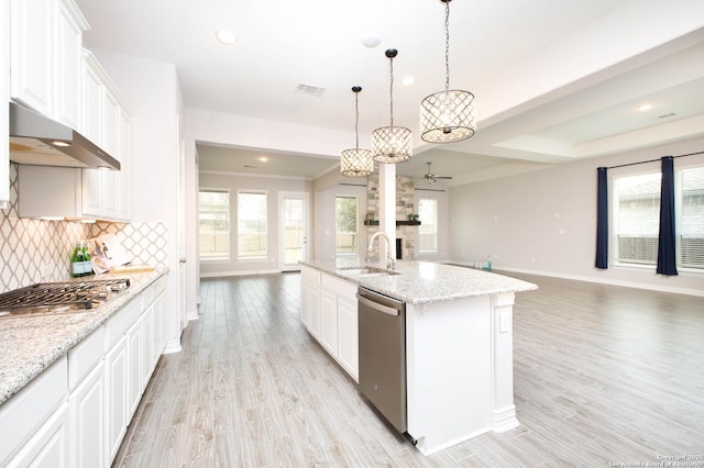 kitchen with white cabinetry, a center island with sink, appliances with stainless steel finishes, and open floor plan