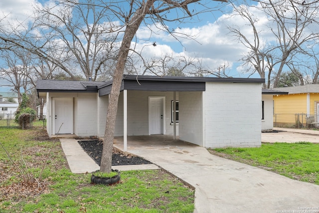 exterior space featuring driveway and an attached carport