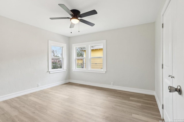 unfurnished bedroom featuring a closet, ceiling fan, light wood finished floors, and baseboards