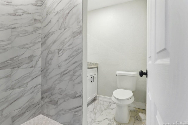 bathroom with toilet, marble finish floor, baseboards, and vanity