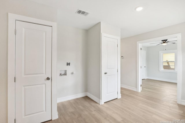 clothes washing area with hookup for a washing machine, light wood-style flooring, hookup for an electric dryer, laundry area, and baseboards