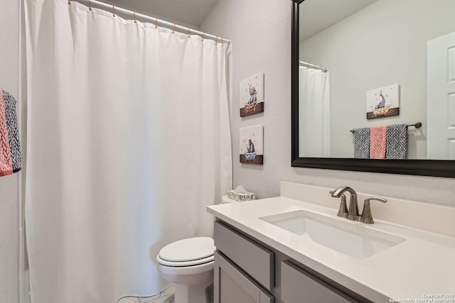 full bathroom featuring toilet and vanity