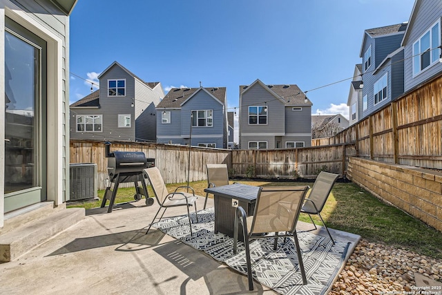 view of patio / terrace featuring a residential view, a fenced backyard, area for grilling, and entry steps