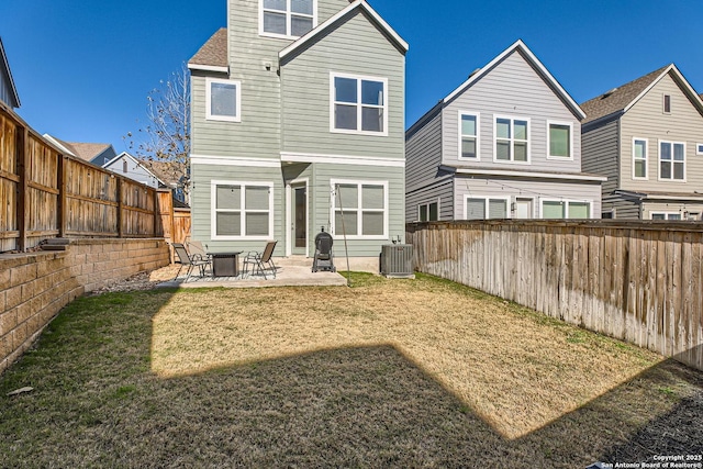 rear view of house with a yard, a patio, a fenced backyard, and central air condition unit