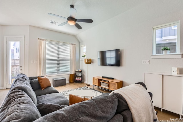 living area with light wood-type flooring, baseboards, visible vents, and a ceiling fan