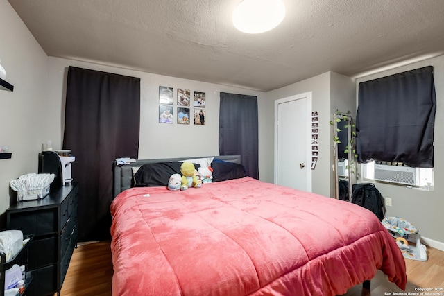 bedroom with dark wood-style flooring and a textured ceiling