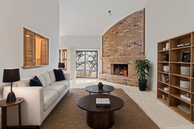 living room with high vaulted ceiling and a brick fireplace