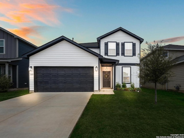 traditional-style house with a garage, board and batten siding, concrete driveway, and a yard